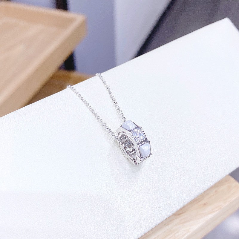 Gold and diamond white mother-of-pearl snake bone necklace
